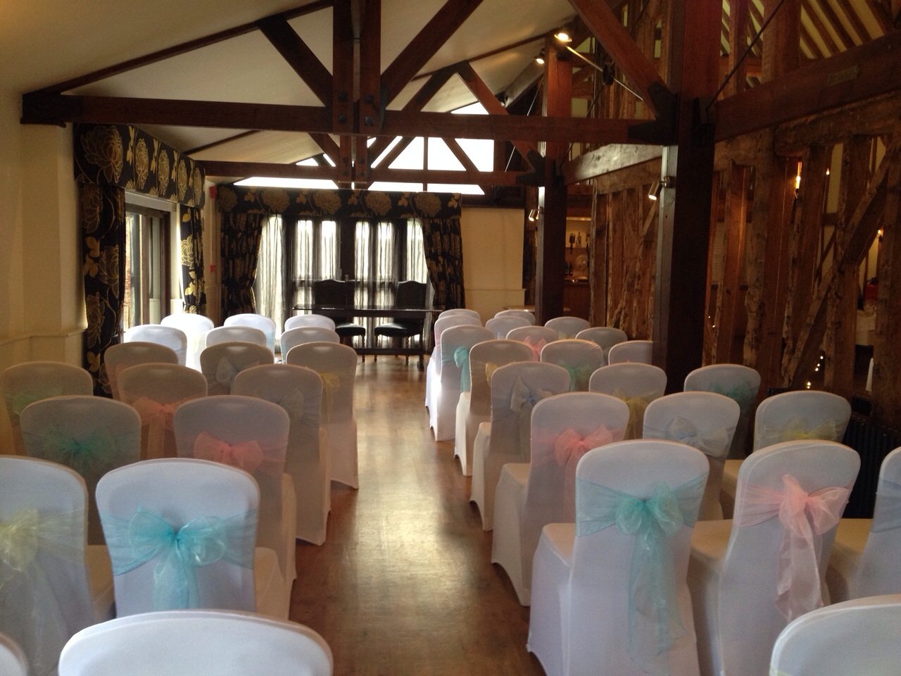 Pastel colour organza sashes with white lycra chair covers at Channels