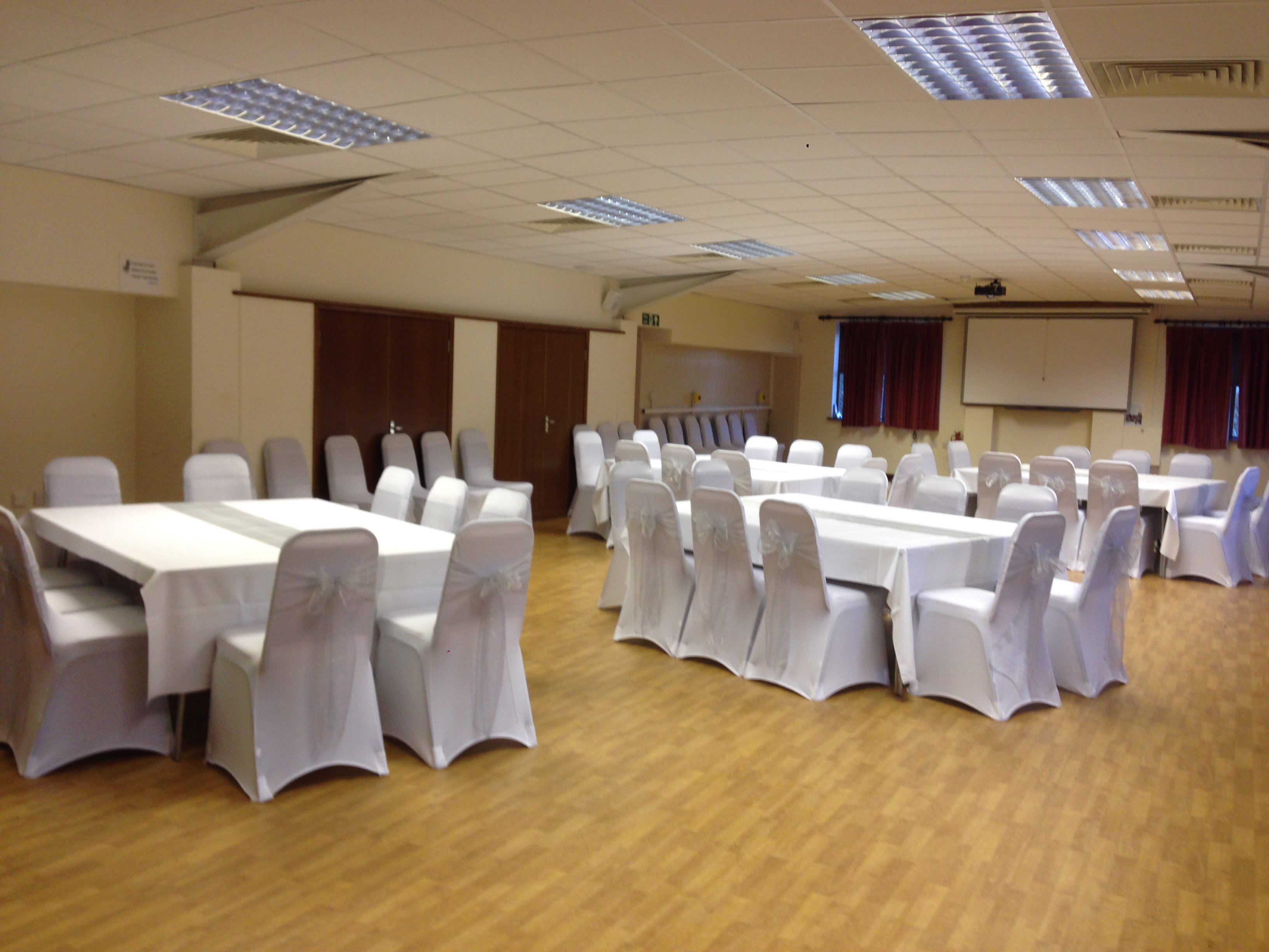 Silver organza sashes and white lycra chair covers at Barleylands function room